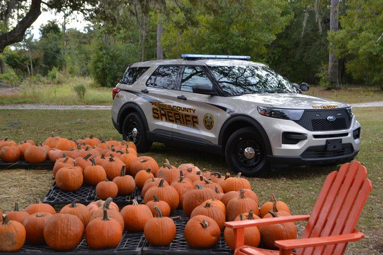Sheriff Cruiser next to pumpkins