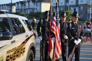 Holding flags by Sheriff Cruiser