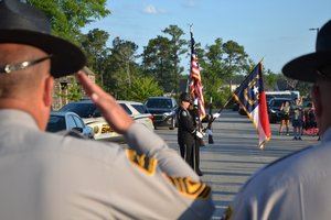 Law Enforcement saluting flag
