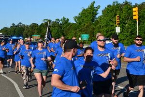 Group of runners wearing blue shirts