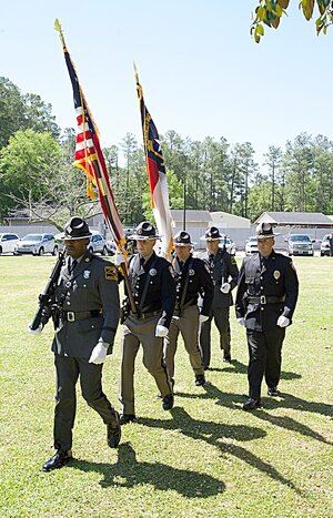 Line of officers carrying flags