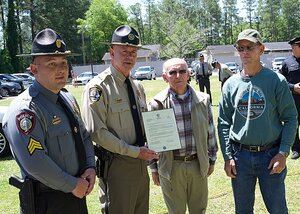 Officer holding plaque