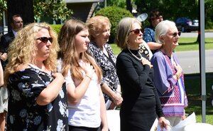 Women with hands on their hearts